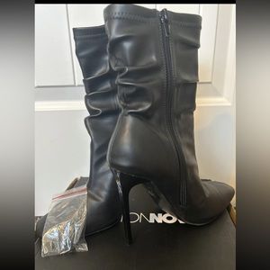 Mid length heeled black boots fall winter